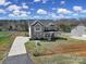 Elegant two-story brick home features a long driveway and manicured front lawn, creating a welcoming approach at 2167 Whispering Winds Dr, Rock Hill, SC 29732