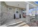 Inviting front porch featuring brick columns, a cozy sitting area, and a decorative wreath on the front door at 2167 Whispering Winds Dr, Rock Hill, SC 29732