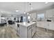 Open floor plan with the kitchen and living areas, featuring a large island, stainless appliances, and modern finishes at 2167 Whispering Winds Dr, Rock Hill, SC 29732