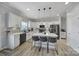 Modern kitchen with white cabinets, sleek black appliances, a quartz island, and stylish pendant lighting above the breakfast bar at 2167 Whispering Winds Dr, Rock Hill, SC 29732