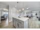 Open-concept kitchen with gray island, pendant lighting, and a view into the dining and living areas, perfect for entertaining at 2167 Whispering Winds Dr, Rock Hill, SC 29732