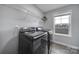 Convenient laundry room equipped with Samsung washer and dryer units, complemented by ample shelving for efficient storage at 2167 Whispering Winds Dr, Rock Hill, SC 29732