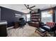 Comfortable home office with a large desk, bookshelf, and ample natural light, creating a productive work environment at 2167 Whispering Winds Dr, Rock Hill, SC 29732