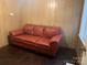 Living Room features wood paneled walls, wood floors, and a comfortable sofa at 2508 Druid Hills Way, Charlotte, NC 28206