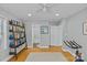 Bright bedroom with hardwood floors, bookshelves, and an ensuite bathroom with a tub/shower combination at 2606 Chesterfield Ave, Charlotte, NC 28205
