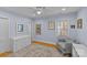 This bedroom features periwinkle walls, hardwood floors, and an accent chair at 2606 Chesterfield Ave, Charlotte, NC 28205