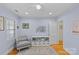 This bedroom features periwinkle walls, hardwood floors, and a gray accent chair at 2606 Chesterfield Ave, Charlotte, NC 28205