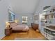 Bright bedroom with hardwood floors features a large window, dresser and built-in shelving at 2606 Chesterfield Ave, Charlotte, NC 28205