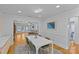 This dining room features a modern chandelier, hardwood floors, and is open to the living room at 2606 Chesterfield Ave, Charlotte, NC 28205