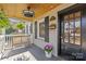 Inviting front porch with wood ceiling, brick facade, and a comfortable bench at 2606 Chesterfield Ave, Charlotte, NC 28205