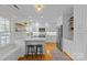 Modern kitchen featuring white cabinets, stainless steel appliances, and a breakfast bar at 2606 Chesterfield Ave, Charlotte, NC 28205