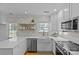 Bright kitchen features white cabinets, stainless steel appliances, farmhouse sink, and quartz countertops at 2606 Chesterfield Ave, Charlotte, NC 28205