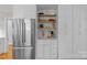 Kitchen with stainless steel refrigerator, custom cabinetry, and open shelving at 2606 Chesterfield Ave, Charlotte, NC 28205