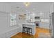 Modern kitchen featuring white cabinets, stainless steel appliances, and a breakfast bar at 2606 Chesterfield Ave, Charlotte, NC 28205