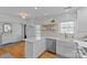 This kitchen features white cabinets, an island with seating, stainless steel appliances, and a farmhouse sink at 2606 Chesterfield Ave, Charlotte, NC 28205
