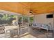 Inviting screened porch with comfortable seating, ceiling fan, TV, and scenic backyard views at 2606 Chesterfield Ave, Charlotte, NC 28205