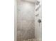 Shower with decorative vertical tiling, a shower head, and built-in shelving niches at 2727 Hilliard Dr, Charlotte, NC 28205