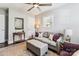 Living room with a neutral sofa, ottoman, accent pillows, and a ceiling fan at 2727 Hilliard Dr, Charlotte, NC 28205
