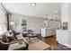 Open-concept layout featuring hardwood floors, a living room area with a sofa, and a kitchen island at 2727 Hilliard Dr, Charlotte, NC 28205