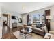 Bright living room featuring hardwood floors, a large window, and a comfortable sofa with stylish pillows at 2727 Hilliard Dr, Charlotte, NC 28205