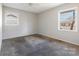 A carpeted bedroom featuring two windows that provide plenty of natural light at 3030 Crawford Ave, Gastonia, NC 28052