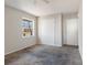 A carpeted bedroom featuring a window and closet at 3030 Crawford Ave, Gastonia, NC 28052