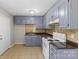A cozy kitchen featuring blue cabinets and modern appliances at 3030 Crawford Ave, Gastonia, NC 28052
