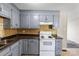 A cozy kitchen featuring blue cabinets and modern appliances at 3030 Crawford Ave, Gastonia, NC 28052