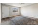 Bright living room featuring neutral walls, large windows, and cozy carpet flooring, creating a welcoming atmosphere at 3030 Crawford Ave, Gastonia, NC 28052