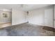 Spacious living room showcasing neutral walls, carpet flooring, and ample natural light, perfect for relaxing and entertaining at 3030 Crawford Ave, Gastonia, NC 28052