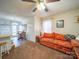 Cozy living room featuring a bright couch, ceiling fan, and an adjacent dining area, perfect for Gathering living at 36533 S South Stanly School Rd, Norwood, NC 28128