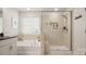 Luxurious bathroom featuring a separate tub, walk-in shower, and modern fixtures at 3878 Fairlady Ln, Fort Mill, SC 29707
