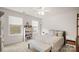 Bright bedroom featuring two windows, a ceiling fan, a bookshelf, and a patterned bed at 3878 Fairlady Ln, Fort Mill, SC 29707
