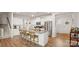 Spacious kitchen with white cabinets, granite countertops, a large island, and stainless steel appliances at 3878 Fairlady Ln, Fort Mill, SC 29707
