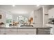 Open kitchen featuring granite countertops, a stainless steel sink, and a view into the dining and living areas at 3878 Fairlady Ln, Fort Mill, SC 29707
