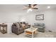 Upstairs den featuring a comfortable sofa, loveseat, ceiling fan, and coffee table at 3878 Fairlady Ln, Fort Mill, SC 29707
