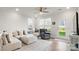Bright living room featuring a sectional sofa, ceiling fan, and hardwood floors at 3878 Fairlady Ln, Fort Mill, SC 29707