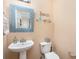 Cozy half bathroom featuring white fixtures, stylish mirror, and a clean modern design at 4214 High Shoals Dr, Monroe, NC 28110