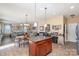 Open-concept kitchen with granite island, stainless steel appliances, and seamless access to the living areas at 4214 High Shoals Dr, Monroe, NC 28110