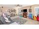 Spacious living room with a cozy fireplace, ceiling fan, and ample play space at 4214 High Shoals Dr, Monroe, NC 28110
