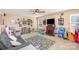 Spacious living room with a cozy fireplace, ceiling fan, and ample play space at 4214 High Shoals Dr, Monroe, NC 28110