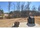 Backyard with a patio, fire pit, grill, and view of the trees at 4246 Millstream Rd, Denver, NC 28037