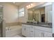 Spa-like bathroom with double vanity, granite countertops, and a luxurious soaking tub at 4246 Millstream Rd, Denver, NC 28037