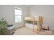 Bright bedroom featuring a wooden bunk bed, plush carpeting, and natural light from a window at 4246 Millstream Rd, Denver, NC 28037