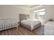 Spacious bedroom featuring plush king-size bed, tray ceiling, and large window at 4246 Millstream Rd, Denver, NC 28037