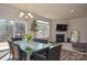 Bright dining area with fireplace, large windows, and hardwood floors at 4246 Millstream Rd, Denver, NC 28037