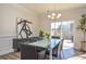 Well-lit dining area with sliding glass door, stylish decor, and hardwood floors at 4246 Millstream Rd, Denver, NC 28037