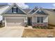 Charming home with blue and beige siding, stone accents, and an attached two-car garage at 4246 Millstream Rd, Denver, NC 28037