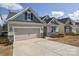 Charming home with blue and beige siding, stone accents, with a two-car garage and driveway at 4246 Millstream Rd, Denver, NC 28037