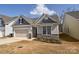 Charming home with blue and beige siding, stone accents, and an attached two-car garage at 4246 Millstream Rd, Denver, NC 28037